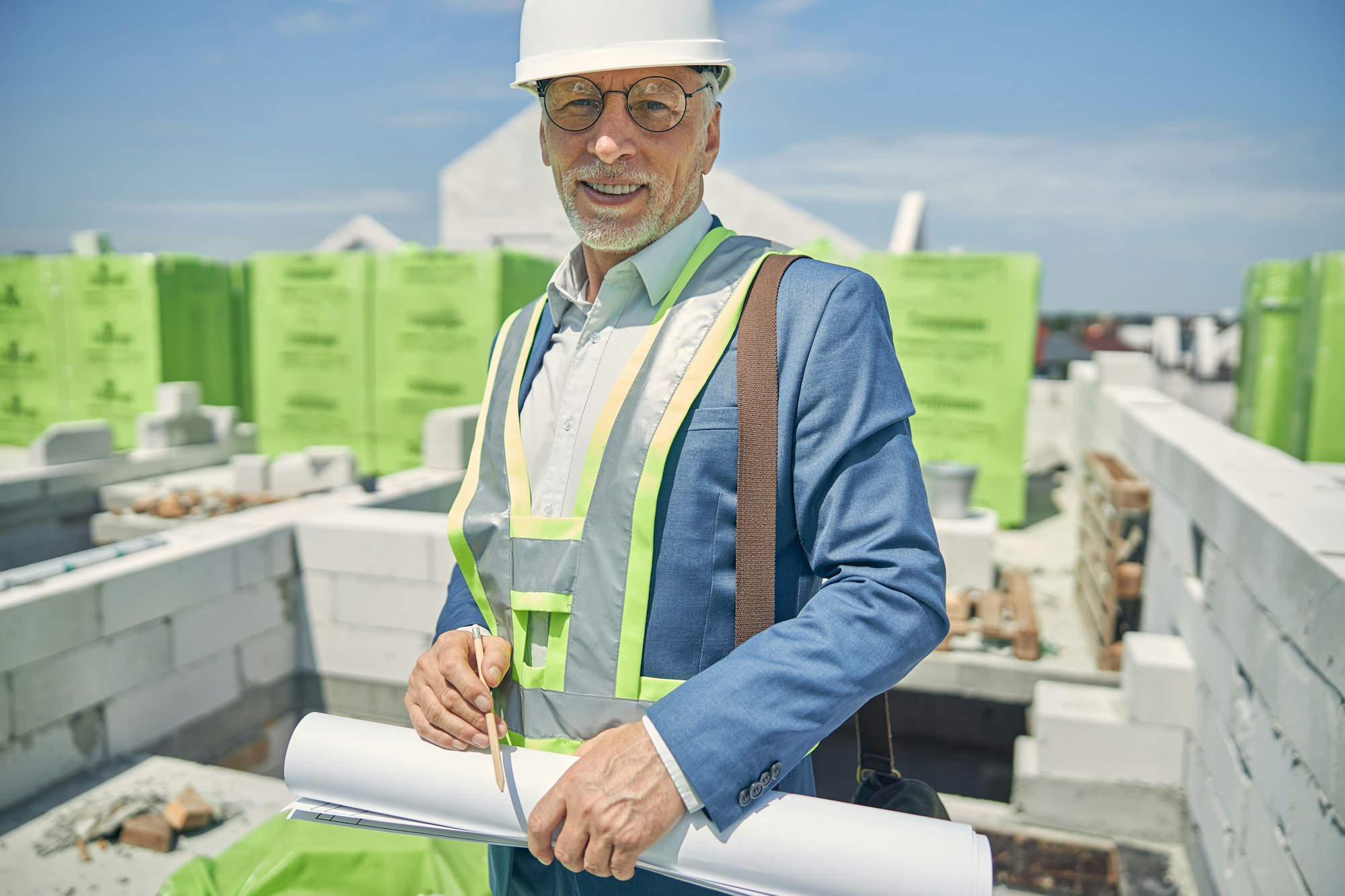 Male constructor standing at a building site