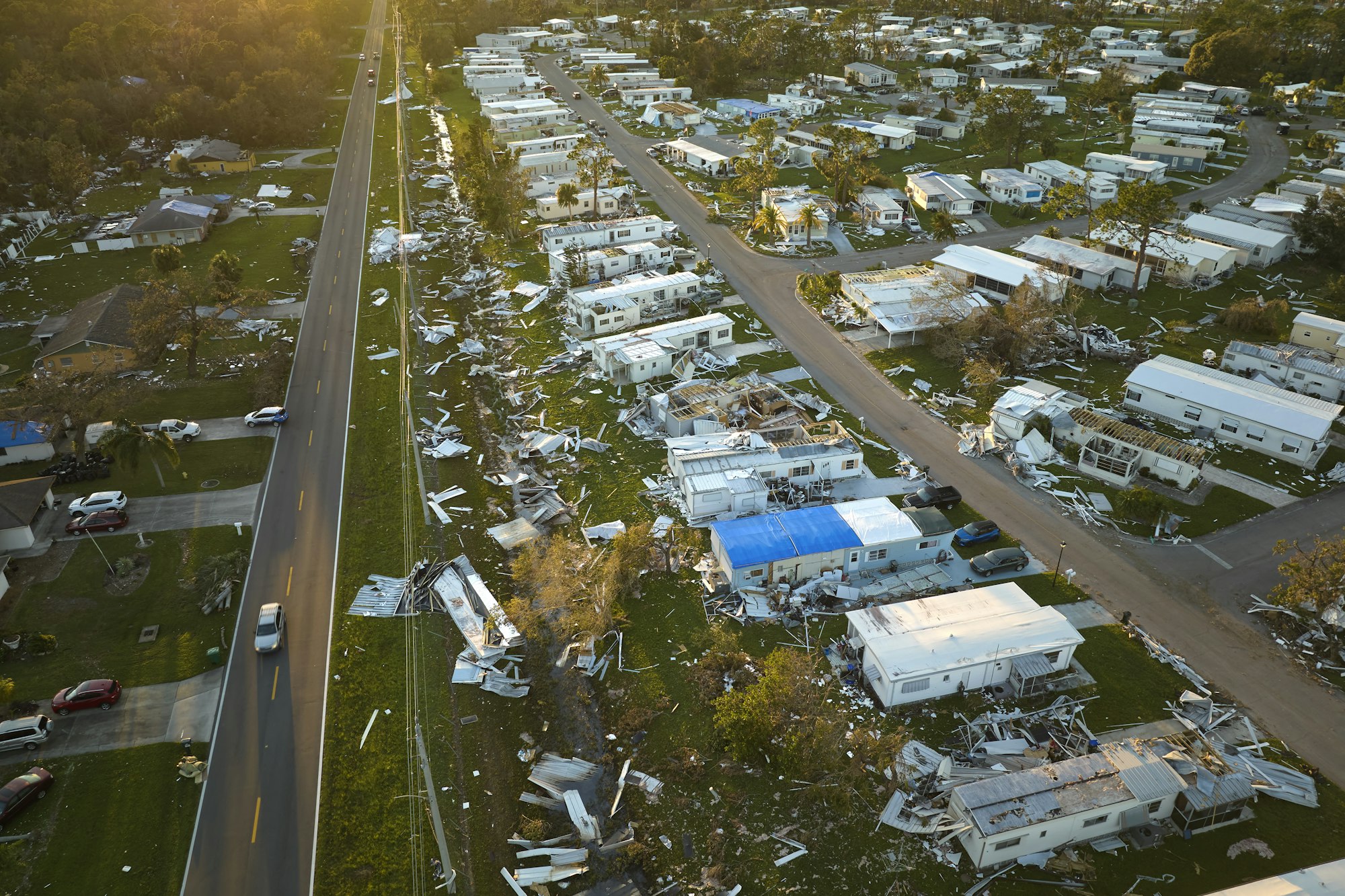 Severely damaged houses after hurricane Ian in Florida mobile home residential area.