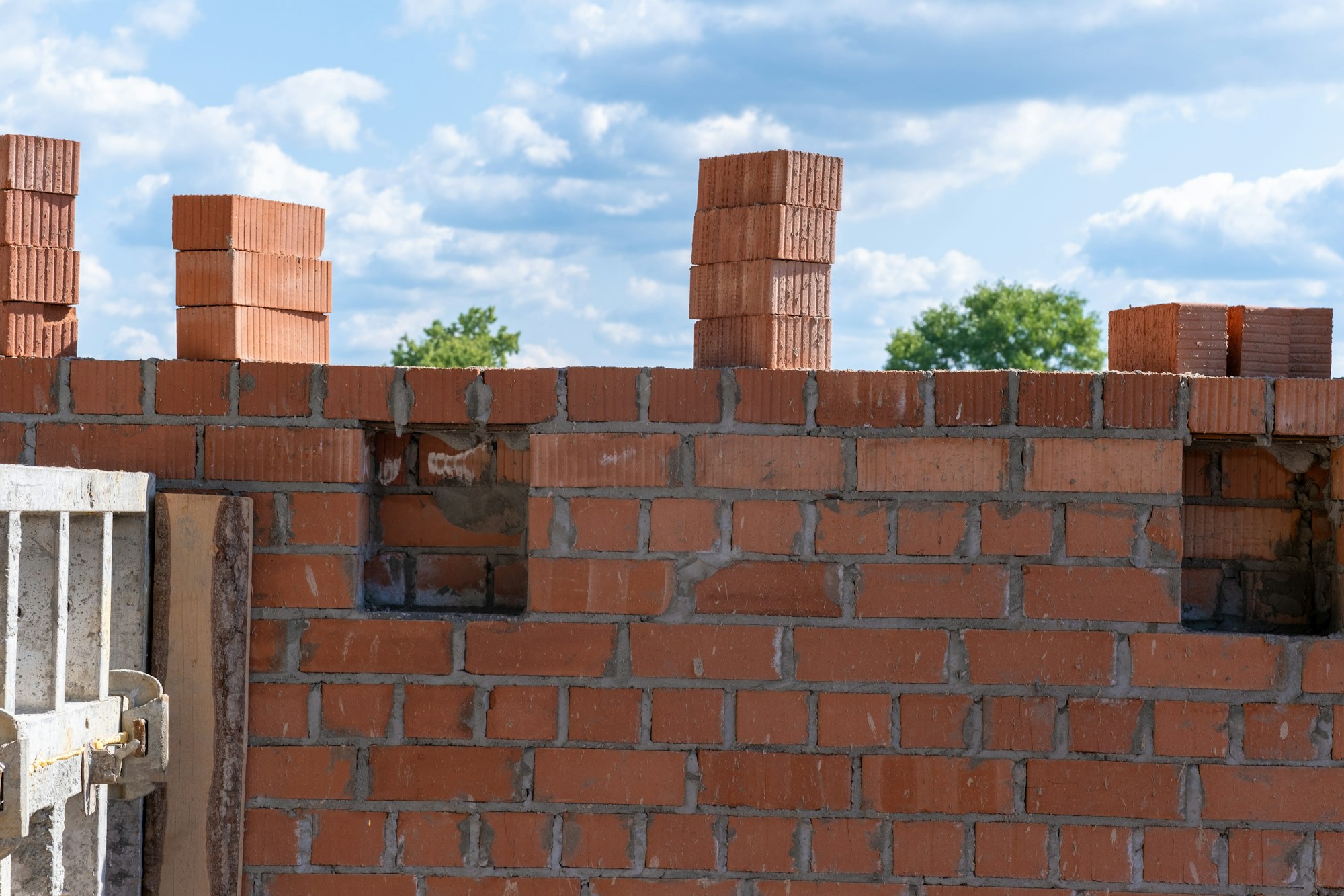 Unfinished brick wall of the house. Brickwork. Construction of a brick wall.